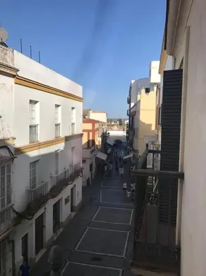 an empty alley between buildings in a city at Piso Acogedor en pleno centro in El Puerto de Santa María