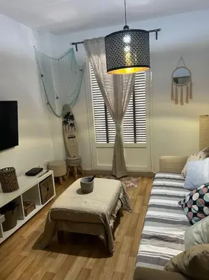 a living room with a couch and a table at Piso Acogedor en pleno centro in El Puerto de Santa María