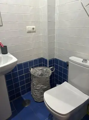 a blue and white bathroom with a toilet and a sink at Piso Acogedor en pleno centro in El Puerto de Santa María