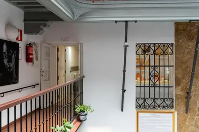 a staircase in a building with a sign on the wall at Hotel Alquimia Cadiz in Cádiz