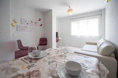 a living room with a table with wine glasses on it at Apartamentos El Ático de Hércules in Cádiz