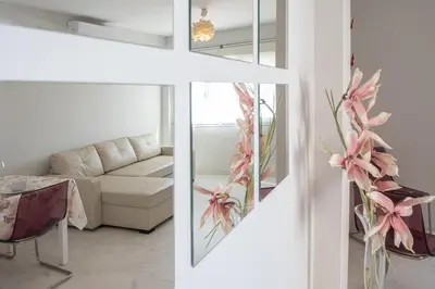 a living room with a couch and a table at Apartamentos El Ático de Hércules in Cádiz
