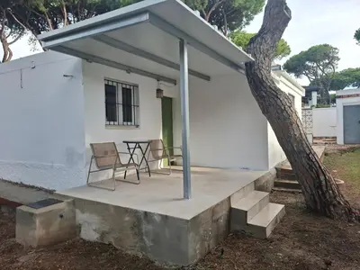 a patio with a table and chairs next to a house at Ugaldenea- Playa in Chiclana de la Frontera