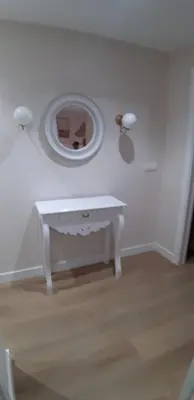 a room with a white table and a mirror at Piso del centro in Sanlúcar de Barrameda
