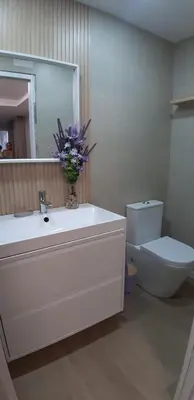 a bathroom with a sink and a toilet and a mirror at Piso del centro in Sanlúcar de Barrameda