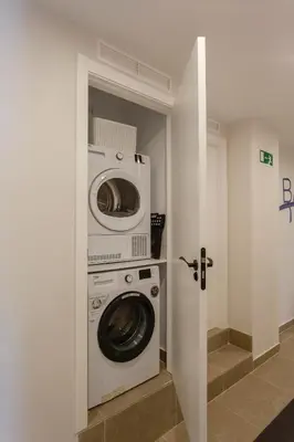 a washer and dryer in a laundry room at BAHIA Suites by Cadiz4Rentals in Cádiz