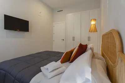 a bedroom with a bed with towels on it at BAHIA Suites by Cadiz4Rentals in Cádiz