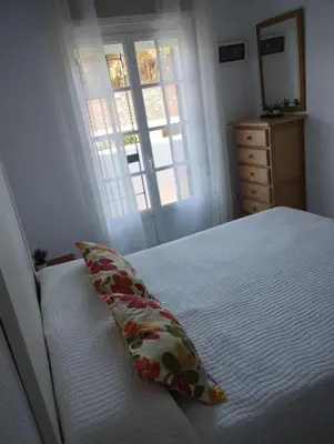 a bedroom with a bed with a pillow on it at La Barrosa, una playa inigualable in Novo Sancti Petri