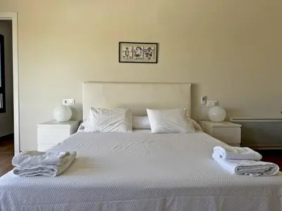 a bedroom with a white bed with two towels on it at Villa Al Alba - Ole Solutions in Sanlúcar de Barrameda