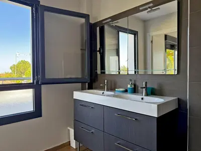 a bathroom with a sink and a mirror at Villa Al Alba - Ole Solutions in Sanlúcar de Barrameda
