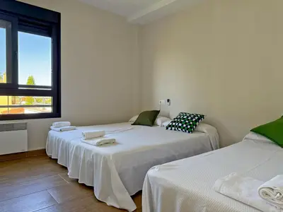 a room with two beds and a window at Villa Al Alba - Ole Solutions in Sanlúcar de Barrameda