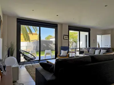 a living room with a couch and a large window at Villa Al Alba - Ole Solutions in Sanlúcar de Barrameda