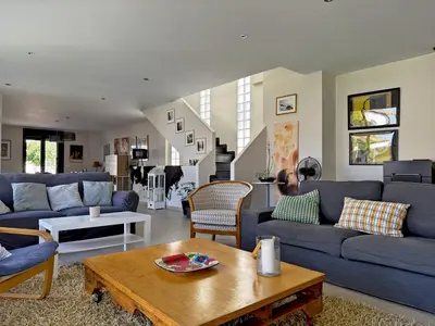a living room with blue couches and a table at Villa Al Alba - Ole Solutions in Sanlúcar de Barrameda