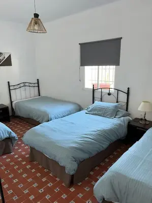 a bedroom with three beds in a room at Rancho-Carita in Bornos