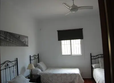 a white room with two beds and a window at Rancho-Carita in Bornos