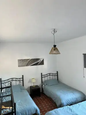 a room with two beds and a lamp at Rancho-Carita in Bornos