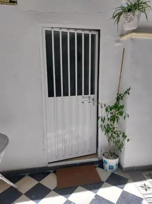 a white door with a plant in front of it at Casatuya in Jerez de la Frontera