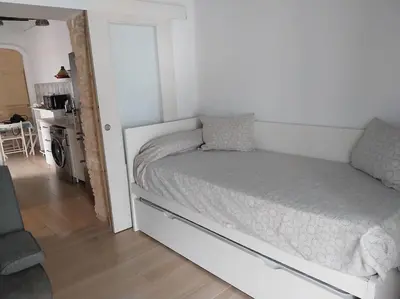 a bedroom with a white bed in a room at Casatuya in Jerez de la Frontera