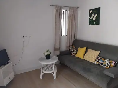 a living room with a couch and a table at Casatuya in Jerez de la Frontera