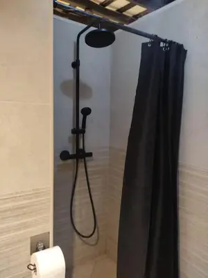 a shower with a black shower curtain in a bathroom at Casatuya in Jerez de la Frontera