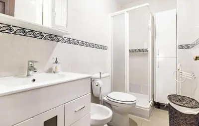 a white bathroom with a toilet and a sink at 2 Bedroom Amazing Apartment In Chipiona in Chipiona