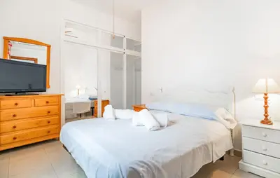 a bedroom with two beds and a flat screen tv at 2 Bedroom Amazing Apartment In Chipiona in Chipiona