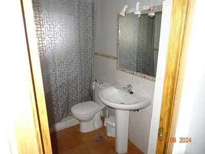 a small bathroom with a toilet and a sink at las olas in Chipiona