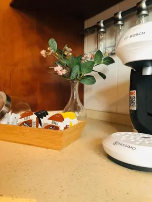 a vase with flowers in it sitting on a counter at Una casa en el lago in Arcos de la Frontera