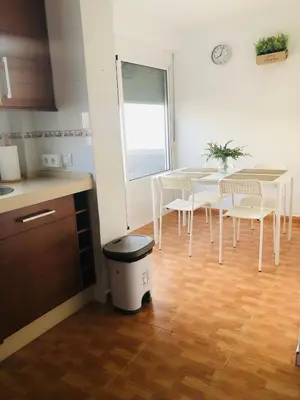 a kitchen with a table and chairs and a table and a window at Una casa en el lago in Arcos de la Frontera