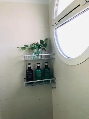 a bathroom with a window and three bottles of soap at Una casa en el lago in Arcos de la Frontera