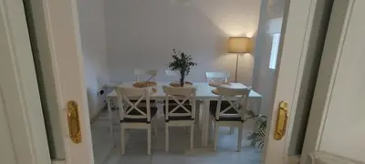 a dining room with a table and chairs at Preciosa casa a 100 m de Bajo de Guía en Sanlúcar in Sanlúcar de Barrameda