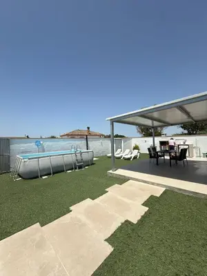 a patio with a table and chairs and the ocean at Casita la ilusión in Conil de la Frontera