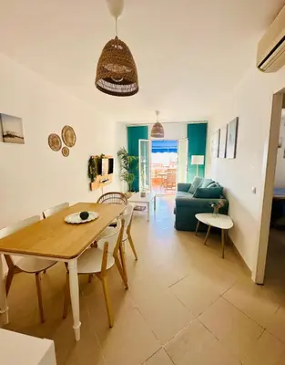 a living room with a table and a couch at Ático horizonte in Sanlúcar de Barrameda