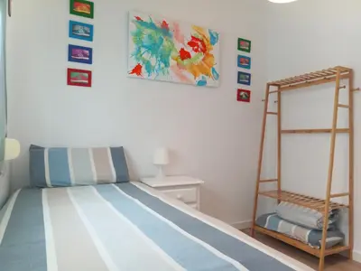 a bedroom with a bunk bed and a ladder at Villasultana 1 in Chipiona
