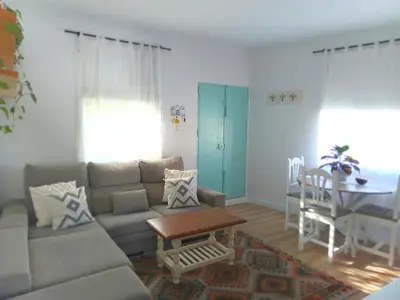 a living room with a couch and a table at Villasultana 1 in Chipiona