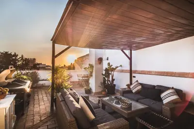 a living room with a couch and a table at Precioso apartamento con terraza independiente en pleno centro in El Puerto de Santa María