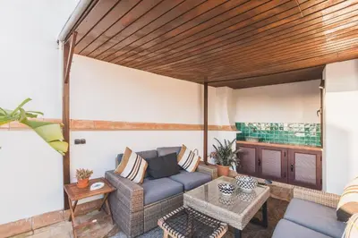 a living room with a couch and a table at Precioso apartamento con terraza independiente en pleno centro in El Puerto de Santa María