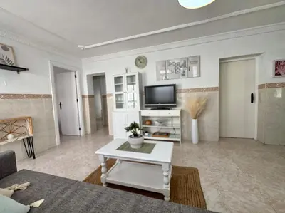 a living room with a couch and a tv at El Cerro de Villasultana, a 3min a pie de playa VUTCA21313 in Chipiona