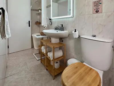 a bathroom with a white toilet and a sink at El Cerro de Villasultana, a 3min a pie de playa VUTCA21313 in Chipiona