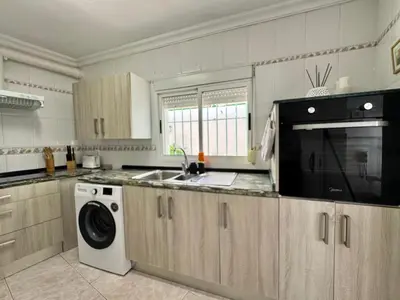a kitchen with a sink and a washing machine at El Cerro de Villasultana, a 3min a pie de playa VUTCA21313 in Chipiona