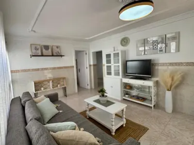 a living room with a couch and a tv at El Cerro de Villasultana, a 3min a pie de playa VUTCA21313 in Chipiona