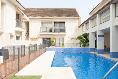 a swimming pool in front of a building at Cimbra 15 in Sanlúcar de Barrameda