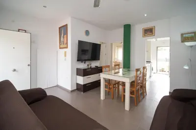 a living room with a table and a television at Cimbra 15 in Sanlúcar de Barrameda