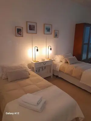 a room with two beds and a table with towels at Acogedor loft a 30 minutos de la playa y montaña in Lebrija