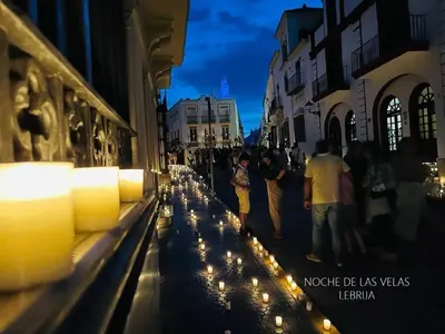 a group of people walking down a street with candles at Acogedor loft a 30 minutos de la playa y montaña in Lebrija