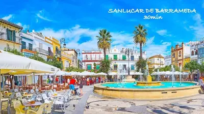 a city square with a fountain and tables and buildings at Acogedor loft a 30 minutos de la playa y montaña in Lebrija