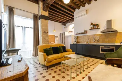a living room with a yellow couch and a kitchen at Allo Apartments Amargura II Centro Loft in Jerez de la Frontera