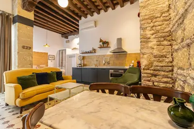 a living room with a yellow couch and a table at Allo Apartments Amargura II Centro Loft in Jerez de la Frontera