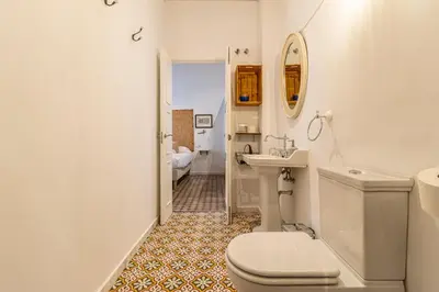 a white bathroom with a toilet and a sink at Allo Apartments Amargura II Centro Loft in Jerez de la Frontera