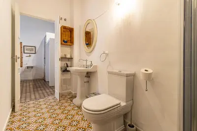 a white bathroom with a toilet and a sink at Allo Apartments Amargura II Centro Loft in Jerez de la Frontera